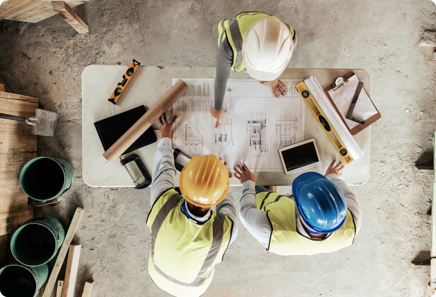 Construction workers reviewing building plans